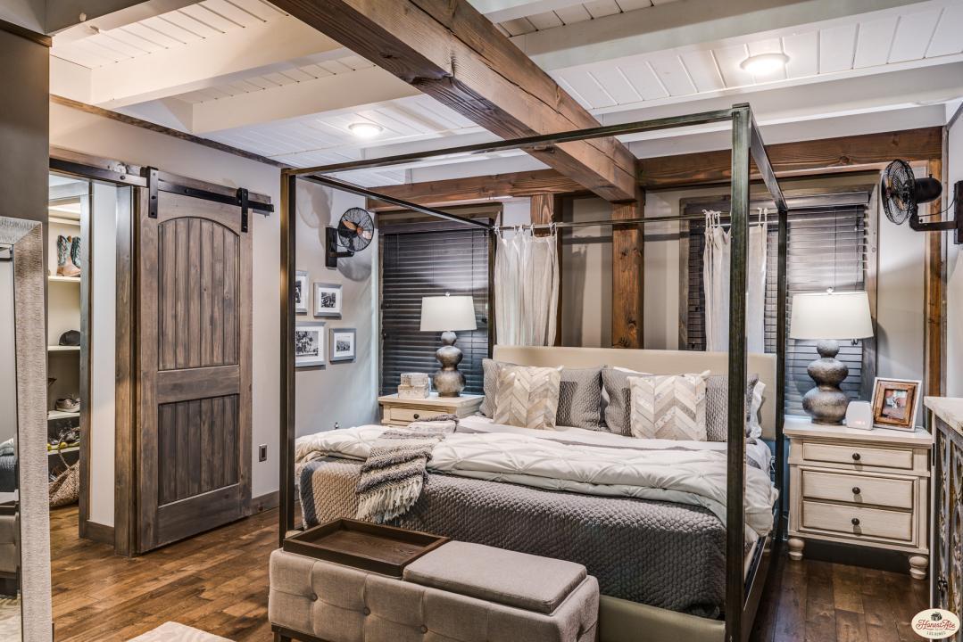 Photo of great room and open kitchen with exposed wood beams and ceiling, dark